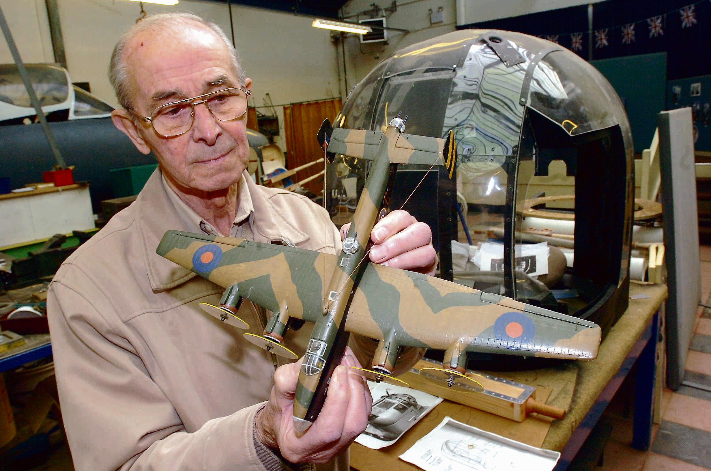 Cyril Plimmer pictured at a Boulton Paull Association open day in 2009, holding a model of a Halifax aircraft