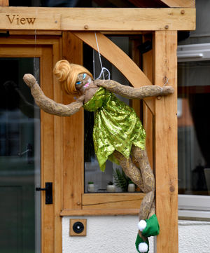 A 'Tinkerbell' scarecrow can be seen outside someone's front door
