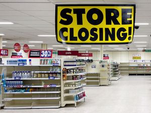 A Wilko store with little on its shelves and a 'store closing' sign