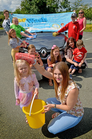 Charity car wash pre pic at Woore village hall. Pictured front is Lorna Reeve with her daughter Chelsea-Mae Bunce age 4 and the Friends of Woore school