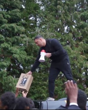 Ste Hamilton giving the trainers away to school pupils