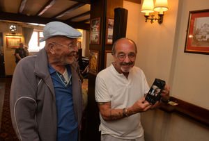 John Smith and Graham Tilley share a joke over Graham's photo with the Prime Minister