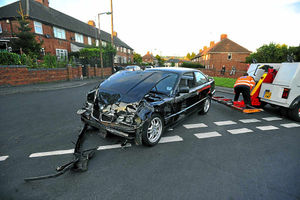 The damaged car is removed from the scene