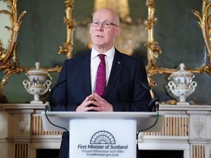 John Swinney speaking from a lectern in Bute House