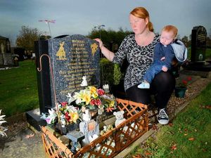 Supporting image for story: Family devastated as engraved jars are taken from son's grave