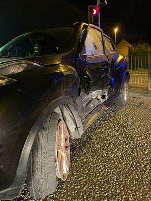 A car's wing was smashed in by the collision.