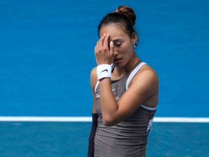 Zheng Qinwen looks dejected during her loss to Laura Siegemund