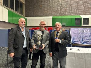 Champion feeling – Gary Beff receives the Whitchurch League championship trophy from Will Ellison and Simon Fullard