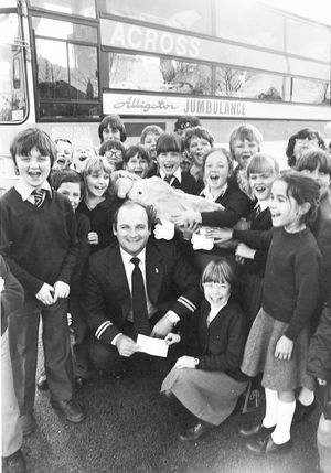 Pupils from St Anne's Primary School, Stafford, raised money for the Across charity, to fund an Alligator Jumbo ambulance, known as a "'jumbulance". The photograph shows pupils presenting a cheque to driver Dave Bruce, in November 1981.