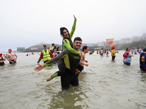 Supporting image for story: Romantic proposal makes waves at Tenby Boxing Day swim