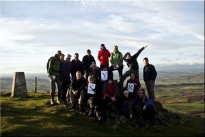 Young ramblers group at the top of a Wales summit
