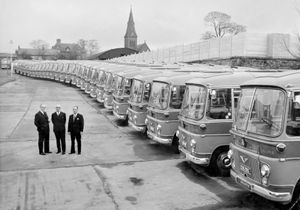 The fleet lines up at Whitchurch at the time of the golden jubilee in 1965. From left: John Else, chairman of West Midland Traffic Commissioners; Harry Richards, managing director; and Tom Davies, general manager.