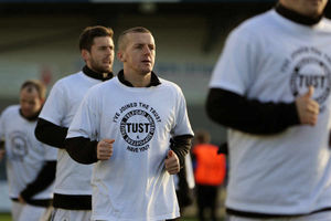 Tony Gray of AFC Telford United warms up before kick-off wearing a T-Shirts saying 'I've joined the Trust have you?' in reference to all the players of AFC Telford United signing up to the club's Trust.