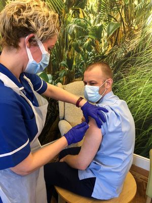 Care practitioner Matthew Brown has the jab