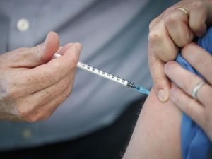 A person receiving a vaccination injection