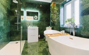 One of the bathrooms has been beautifully decorated with emerald-green tiles. Picture: Purplebricks