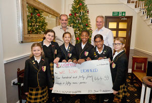 Lichfield Cathedral School pupils present a cheque to We Love Lichfield's Simon Price and Julian Fisher having raised £445 during the Autumn term