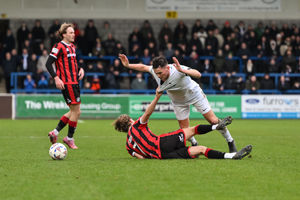 Bucks midfielder Alex Fletcher is hauled down by Joshua Tobin