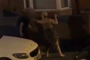 Disturbing footage shows a knife-wielding woman wildly swinging a blade while trying to slash a man in the street - before he fended her off with his rucksack. The shocking confrontation was captured on camera in the Sparkhill area of Birmingham after a disturbance between the pair broke out on Friday night (18/7). The woman can be heard racially abusing the Asian male while brandishing a large blade outside a terraced house. The man then picks up a piece of cardboard and begins to strike her with it before she then chases him down the street with the knife. The two can be heard trading insults , calling each other fat, before the woman begins slashing at him with the blade in the middle of the residential street.