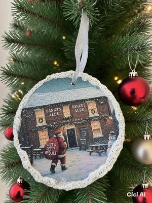 A Christmas tree decoration with Santa visiting the Crooked House