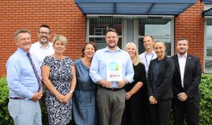 Andrew Hustwit, centre, Head of Business Development shows off the Living Wage plaque with BCRS Business Loans colleagues