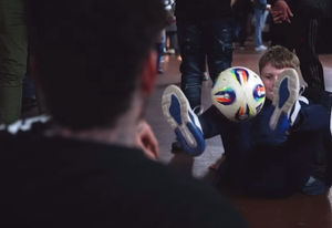 Rosa teaches a young fan some impressive freestyle football tricks.
