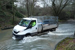 A vehicle passes through floodwater in Houndsfield Lane, Birmingham. Photo: Jacob King/PA Wire