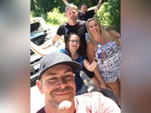 Julian Wilson, David Bentley and Adrian Harrold (left to right) picture with one of their cars and two unidentified women