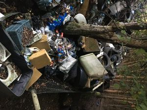 Waves of waste threaten to buckle fence at the bottom of the hill by the layby. Photo: Rob Skinner.