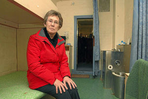 Independent Monitoring Board chairman Carol Byng sits in one of the cells