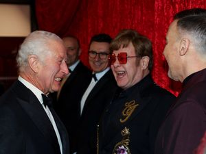 The King grins as he meets Sir Elton John and David Furnish at the Royal Variety Performance at the Royal Albert Hall last November