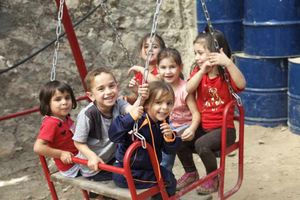 Palestinian children play in the kindergarten in the H2 area of Hebron. Their bags are searched at checkpoints on their way to school