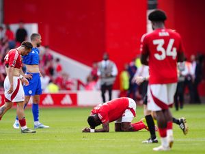 Taiwo Awoniyi lies in pain on the pitch