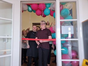Colleagues at Swallow Fields Care scheme cut the ribbon for the redecorated Gallery room
