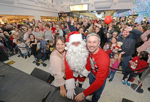 Ed and Jo pictured with Father Christmas as he switches on the Christmas lights at Telford Centre