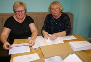Ann and Susan busy stuffing the Tree of Light envelopes.