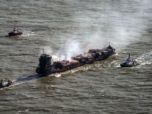 Tug boats shadowing the Solong container ship