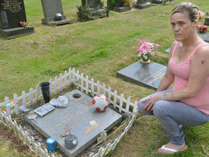Supporting image for story: Family forced to tidy baby son's grave