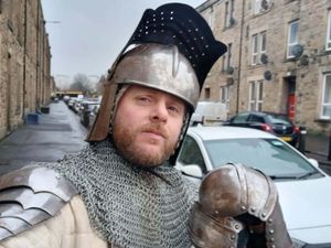 Callum Maclean on a street in full armour