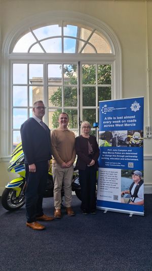 Mr Campion with Dave and Sue Evans and the banner telling Simon's story.