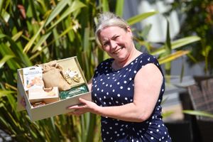 Deputy Manager, Sarah Scriven, with some of the sweet treats donated by Barratt Homes