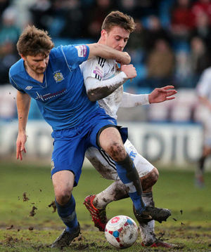 Adam Cowen of Stockport County and Adam Farrell of AFC Telford United