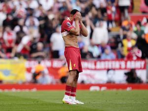 Trent Alexander-Arnold covers his face with his shirt