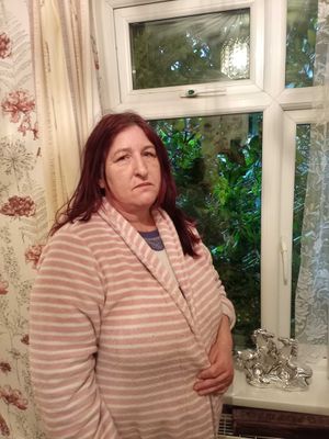 Gail Manning in her living room with the tree up against her window