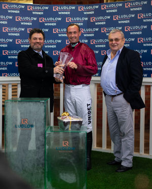 Jack Limond from The White Horse, Clun, presents the trophy to the winners of the Ludlow Brewing Company Handicap Chase. Photo: Aaron Wilson