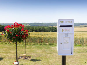 Supporting image for story: 'Letters to heaven’ postbox unveiled in funeral home's rose garden