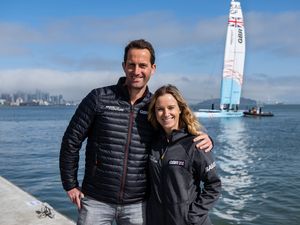 Handout photo dated 24/03/2022 provided by SailGP of Ben Ainslie, driver of Great Britain SailGP Team, and Hannah Mills of Great Britain SailGP Team posing in front of the new Great Britain SailGP Team F50 catamaran at the technical base ahead of San Francisco SailGP, Season 2 in San Francisco, USA