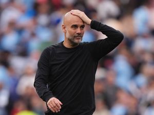 Manchester City manager Pep Guardiola with hand on head