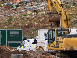 Police officers during the search of part of a landfill site