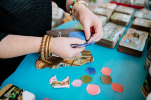 Lyn tears each piece of paper by hand